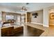 Bright living room featuring tile and hardwood floors, ceiling fan, and an adjacent dining area at 10601 India Hawthorn Ave, Las Vegas, NV 89144