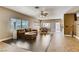 Spacious living room boasts tile flooring and a large leather couch at 10601 India Hawthorn Ave, Las Vegas, NV 89144