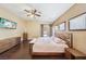 Spacious bedroom with wood floors, ceiling fan, and access to the outdoor patio area at 10601 India Hawthorn Ave, Las Vegas, NV 89144