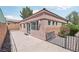 Back patio featuring a textured exterior wall with sliding glass doors and stone landscaping at 10601 India Hawthorn Ave, Las Vegas, NV 89144