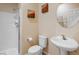 Clean bathroom featuring a white toilet, sink and shower with decorative wall art at 11219 Castellane Dr, Las Vegas, NV 89141