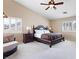 Expansive bedroom featuring neutral walls, vaulted ceilings, and a chair and ottoman at 11219 Castellane Dr, Las Vegas, NV 89141