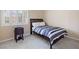 Cozy bedroom with natural light, comfortable carpet, and side table at 11219 Castellane Dr, Las Vegas, NV 89141