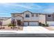 Two-story home showcasing neutral stucco, a three-car garage, and a well-maintained front yard at 11219 Castellane Dr, Las Vegas, NV 89141