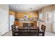 Kitchen with wood table, white cabinets, a center island, stainless appliances, and lots of natural light at 11219 Castellane Dr, Las Vegas, NV 89141
