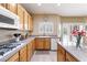 Well-lit kitchen featuring wood cabinets, granite countertops, island, and stainless appliances at 11219 Castellane Dr, Las Vegas, NV 89141