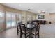 Open living space with a dining table, access to a pool, and a comfortable seating area illuminated by natural light at 11219 Castellane Dr, Las Vegas, NV 89141