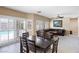Bright living area featuring an eating nook, a sliding glass door with pool access, and comfortable sectional seating at 11219 Castellane Dr, Las Vegas, NV 89141