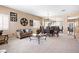 Open-concept living room featuring a couch, dining area, and a large mirror creating an inviting and spacious atmosphere at 11219 Castellane Dr, Las Vegas, NV 89141