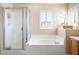 This spacious bathroom has a separate shower and soaking tub with a window at 11219 Castellane Dr, Las Vegas, NV 89141
