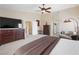 This spacious primary bedroom boasts a ceiling fan, sitting area and adjoining primary bath at 11219 Castellane Dr, Las Vegas, NV 89141