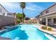 This backyard features a sparkling swimming pool plus a covered patio for outdoor entertaining at 11219 Castellane Dr, Las Vegas, NV 89141