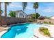 A backyard features a sparkling pool with a rock waterfall plus lounge chairs on the pool deck at 11219 Castellane Dr, Las Vegas, NV 89141