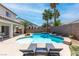 Resort-style backyard with a sparkling pool, lounge chairs, and mature trees for ultimate relaxation at 11219 Castellane Dr, Las Vegas, NV 89141