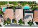 Aerial view of the property reveals a backyard pool and solar panels on the roof next to neighboring homes at 11618 Costa Linda Ave, Las Vegas, NV 89138