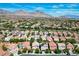 This aerial view shows the property's location in a Las Vegas neighborhood with views of the surrounding mountains at 11618 Costa Linda Ave, Las Vegas, NV 89138