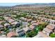 The aerial view captures the residential neighborhood with nearby amenities, showcasing community living with distant mountain scenery at 11618 Costa Linda Ave, Las Vegas, NV 89138