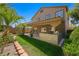 A fully landscaped backyard features a built-in grill, a green lawn, and a covered patio for outdoor entertaining at 11618 Costa Linda Ave, Las Vegas, NV 89138