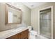 Bathroom with granite-topped vanity, large mirror, and glass-enclosed shower at 11618 Costa Linda Ave, Las Vegas, NV 89138