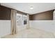 A brown bedroom with white wainscoting, large windows, and French doors at 11618 Costa Linda Ave, Las Vegas, NV 89138