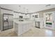 Modern kitchen featuring white cabinets, stainless steel appliances, a center island, and ample counter space at 11618 Costa Linda Ave, Las Vegas, NV 89138