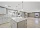 Modern kitchen featuring a large island, stainless steel appliances, and a view into the large living space at 11618 Costa Linda Ave, Las Vegas, NV 89138