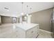 Open kitchen with large island, pendant lighting, and tile flooring at 11618 Costa Linda Ave, Las Vegas, NV 89138
