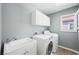 Functional laundry room with cabinets, sink, washer, and dryer at 11618 Costa Linda Ave, Las Vegas, NV 89138
