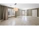 Open floor plan with tile flooring, neutral paint, and ample natural light from large windows at 11618 Costa Linda Ave, Las Vegas, NV 89138