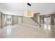 Open living area features tile floors, staircase, natural light, and neutral paint scheme at 11618 Costa Linda Ave, Las Vegas, NV 89138