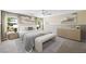 Relaxing main bedroom featuring large windows, neutral tones, contemporary art and a sitting bench at 11618 Costa Linda Ave, Las Vegas, NV 89138