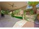 Spacious outdoor patio area featuring a covered seating area and a well-manicured lawn at 11618 Costa Linda Ave, Las Vegas, NV 89138
