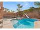 Poolside shot of a sparkling swimming pool and hot tub with backyard landscaping and privacy walls at 11784 Golden Moments Ave, Las Vegas, NV 89138