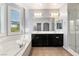 Bright bathroom showcasing a soaking tub, a double sink vanity, and a glass enclosed shower at 11784 Golden Moments Ave, Las Vegas, NV 89138