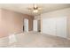 Spacious bedroom featuring neutral carpet, a ceiling fan, and a sizable closet at 11784 Golden Moments Ave, Las Vegas, NV 89138