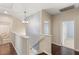 Bright upstairs hallway with hardwood floors, staircase, and views into the bathrooms and bedrooms at 11784 Golden Moments Ave, Las Vegas, NV 89138