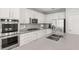 Modern kitchen featuring stainless steel appliances and a tile backsplash at 11784 Golden Moments Ave, Las Vegas, NV 89138