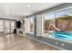 Bright living room with views of a private backyard featuring a sparkling pool and a slide at 11784 Golden Moments Ave, Las Vegas, NV 89138