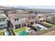 Aerial view of backyards with pools, spas, covered patios, and artificial turf, showcasing outdoor living spaces at 12053 Arrebol Ave, Las Vegas, NV 89138
