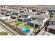 Aerial view of backyards with pools, spas, covered patios, and manicured lawns, illustrating outdoor amenities at 12053 Arrebol Ave, Las Vegas, NV 89138