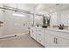 Modern bathroom featuring dual sinks, quartz counters, and walk-in shower with neutral flooring at 12053 Arrebol Ave, Las Vegas, NV 89138