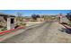 Gated community entrance ensuring privacy and security, featuring stone pillars, landscaping and wrought iron gates at 12053 Arrebol Ave, Las Vegas, NV 89138