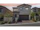 Charming two-story home boasts a neutral color scheme, a well-maintained front yard, and a two-car garage at 12053 Arrebol Ave, Las Vegas, NV 89138