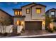 Charming two-story home boasts a neutral color scheme, a well-maintained front yard, and a two-car garage at 12053 Arrebol Ave, Las Vegas, NV 89138