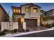 Charming two-story home boasts a neutral color scheme, a well-maintained front yard, and a two-car garage at 12053 Arrebol Ave, Las Vegas, NV 89138