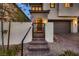 Inviting front entrance features a gated courtyard, steps leading to the door, and manicured landscaping at 12053 Arrebol Ave, Las Vegas, NV 89138