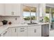 The kitchen is equipped with stainless steel dishwasher and white cabinets at 12053 Arrebol Ave, Las Vegas, NV 89138