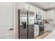 Updated kitchen with stainless steel refrigerator and bright, white cabinets at 12053 Arrebol Ave, Las Vegas, NV 89138
