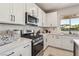 Bright kitchen features stainless steel appliances and white cabinetry at 12053 Arrebol Ave, Las Vegas, NV 89138