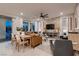 Spacious living room features a brick accent wall, stylish furnishings, and abundant natural light at 12053 Arrebol Ave, Las Vegas, NV 89138